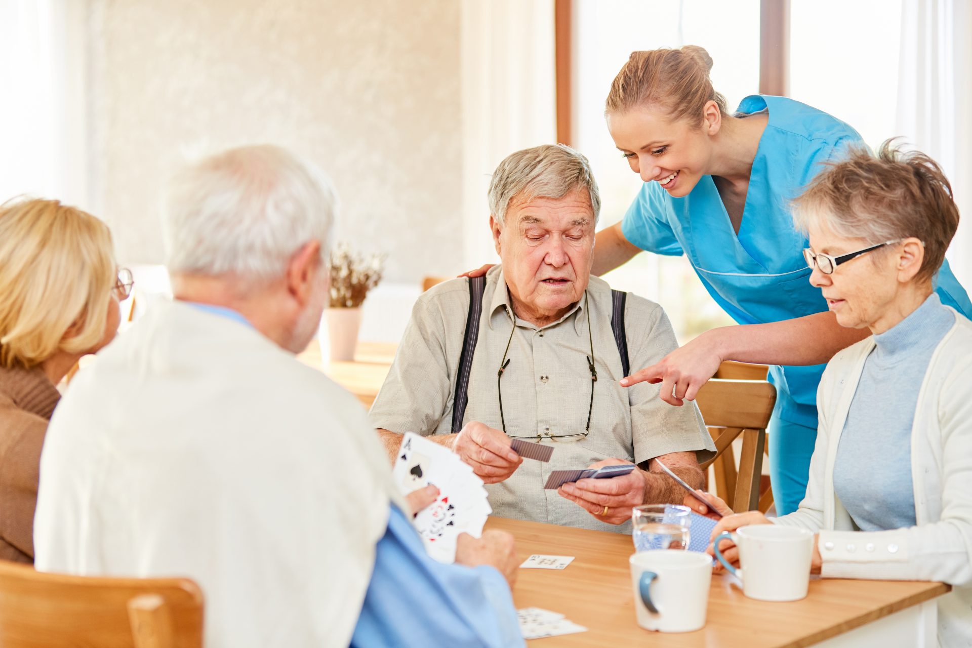 Caregiver assisting elderly residents at a senior living facility